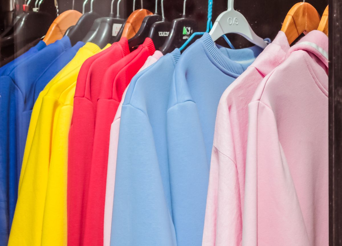 Crewneck sweatshirts in bright colors on hangers